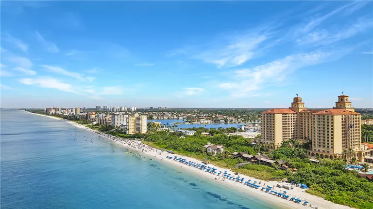Naples skyline with tropical beachfront and clear blue skies.