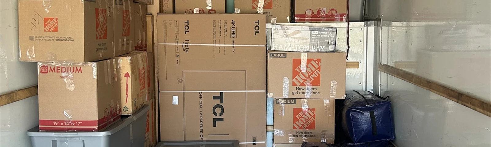 Interior of a warehouse with stacked boxes and pallets for logistics and distribution.