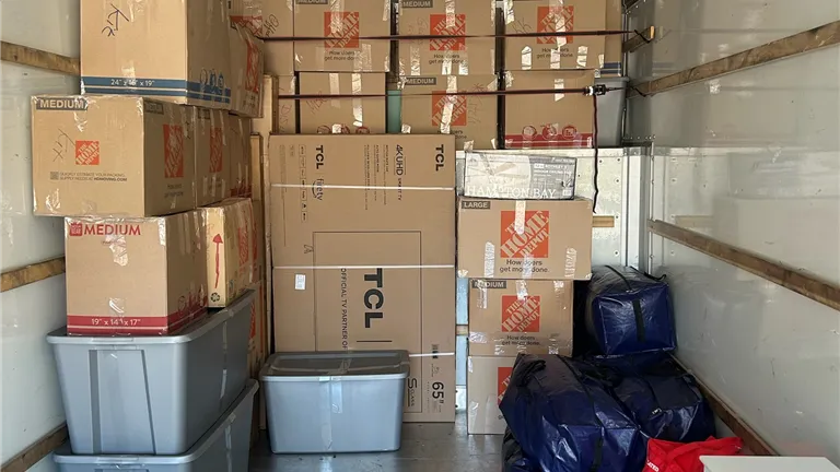 Interior of a warehouse with stacked boxes and pallets for logistics and distribution.