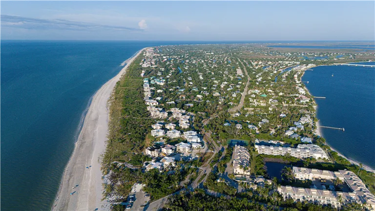 Stunning aerial photo of Sanibel Island, FL, showcasing the coastline and residential areas.